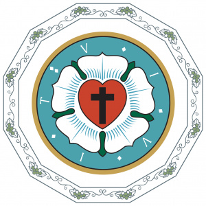 Piirretyssä kuvassa on niin sanottu Luther-ruusu, jonka keskellä on sydän, jonka keskellä on risti.